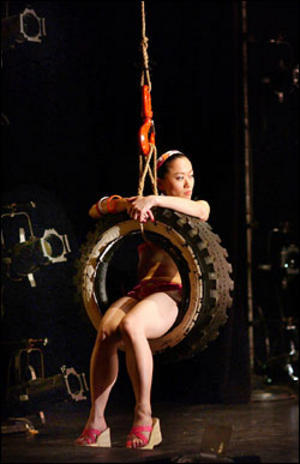 SITI member Akiko Aizawa swings through bobrauschenbergamerica. Photo: Michael Brosilow.